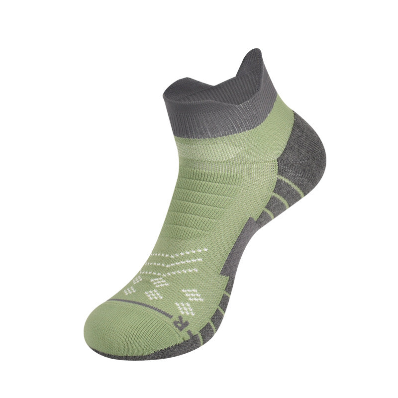 Performance athletic ankle socks in black and gray worn on feet lifestyle shot